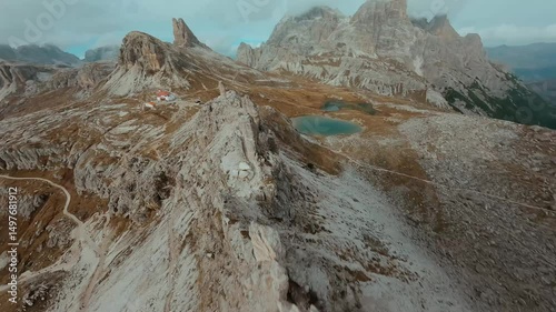 FPV drone flying close to the sharp mountain cliffs. Italy, Dolomites