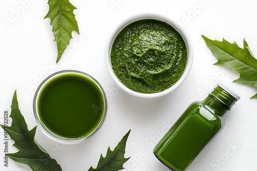 Neem leaves and paste in a white bowl, with neem juice on an isolated background