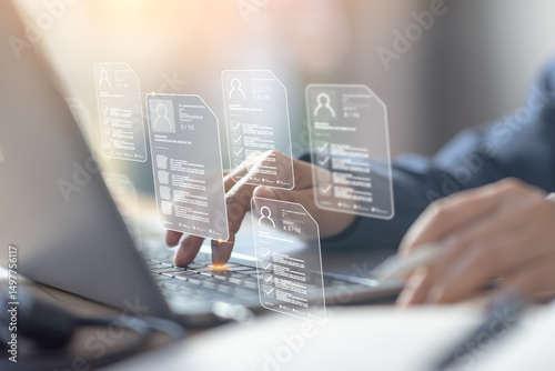 Bild auf Leinwand HR professional conducts digital resume screening, reviewing multiple CVs online