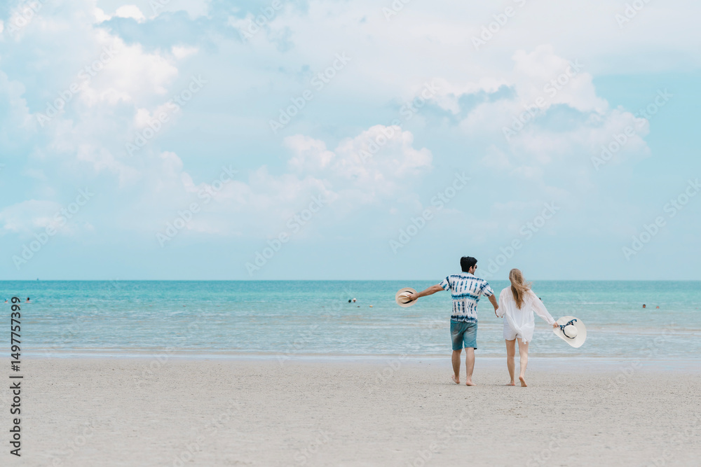 young couple walking on white sand beach on paradise island. Caucasian couple enjoy outdoor luxury at paradise beach. lifestyle people vacation holiday on beach in tropical sea. summer, travel. young couple walking on white sand beach on paradise island. Caucasian couple enjoy outdoor luxury at paradise beach. lifestyle people vacation holiday on beach in tropical sea. summer, travel.