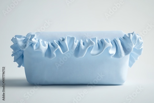 A light blue rectangular box with frills on the top edge on a white surface in a studio setting