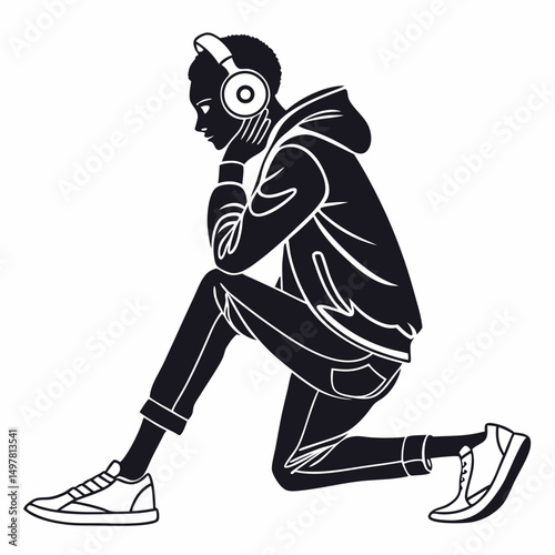 Young man listening music headphones silhouette kneeling pose