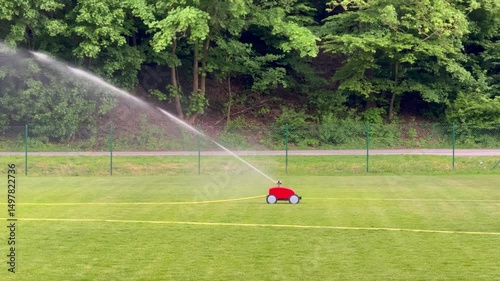 Automatic sprinkler watering green sports field lawn
