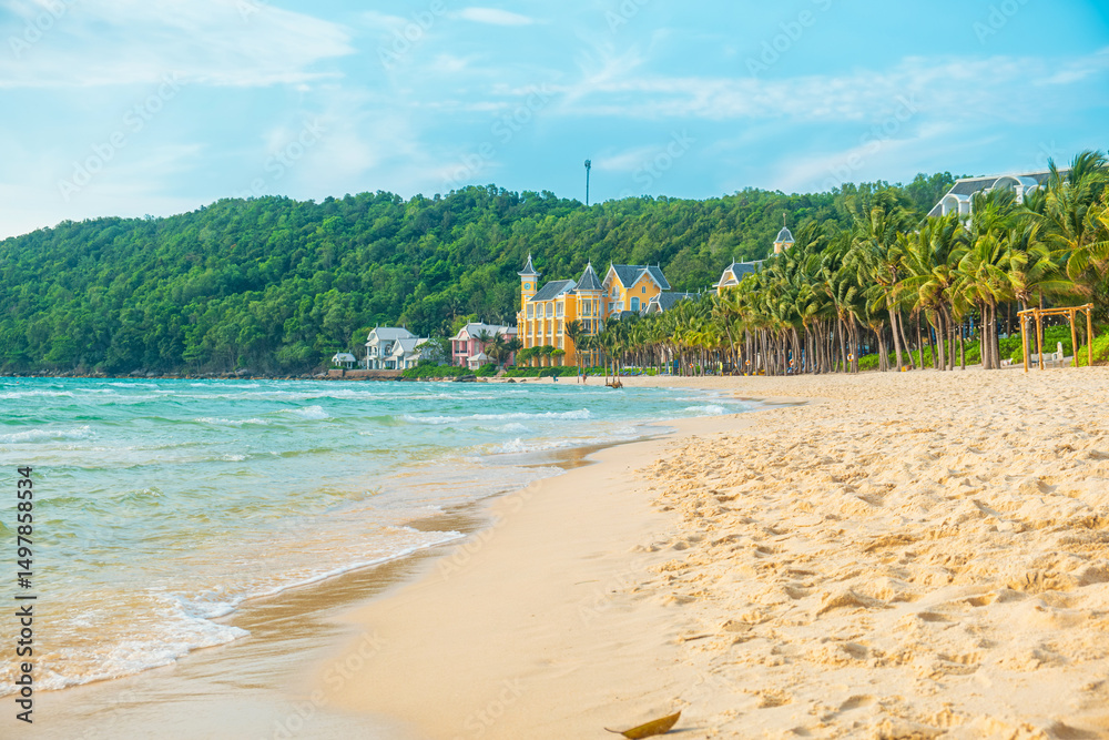 Obraz premium Tropical beach with golden sand, turquoise sea, palm trees and colorful seaside resort buildings with nobody, Phu Quoc island, Vietman. Khem beach. Summer vacation destination in Asia
