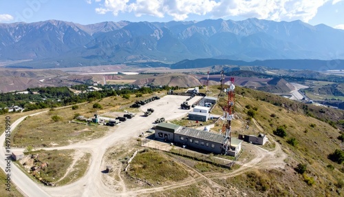 Aerial View of Military Base with Vehicles, Radar and Communication Towers photo
