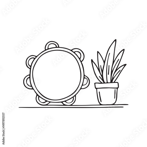 A tambourine placed near a potted plant