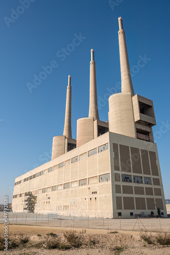 The imposing shutdown thermal power station at Sant Adria near Barcelona with its iconic three smoke stacks