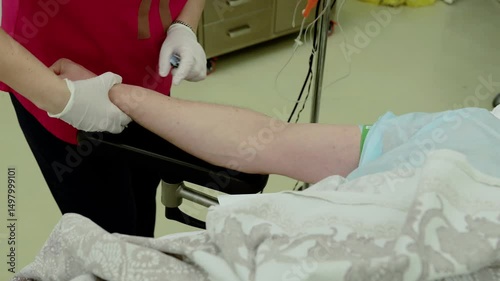 Healthcare worker inserting iv catheter into patient arm, wearing protective gloves, delivering careful medical intervention with sterile equipment in hospital environment