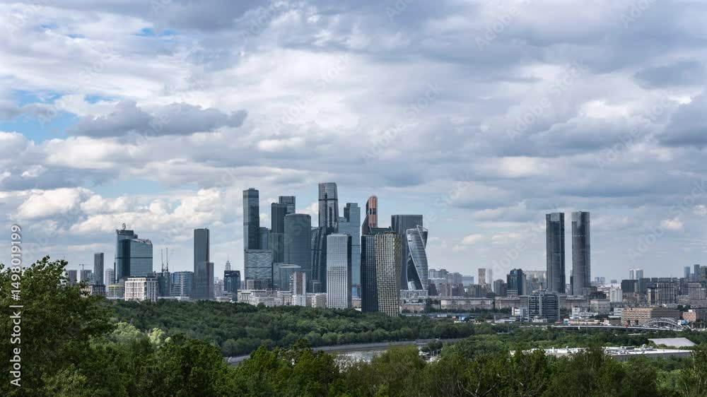 A time lapse stunning view of a modern city skyline with sleek skyscrapers rising against a moody sky filled with fluffy clouds, reflecting contemporary urban architecture and design in Moscow, Russia A time lapse stunning view of a modern city skyline with sleek skyscrapers rising against a moody sky filled with fluffy clouds, reflecting contemporary urban architecture and design in Moscow, Russia