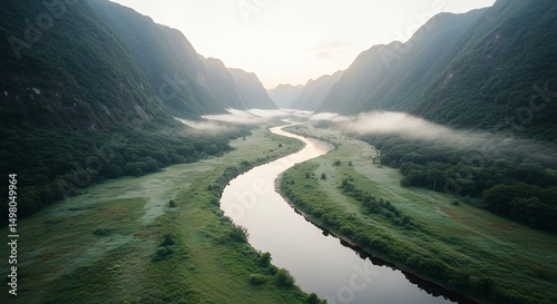 River Flowing Through Valley Landscape at Sunrise