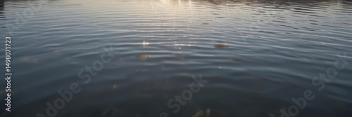 Sun-kissed water, gentle ripples shimmer across a calm lake surface ,  sunlight,  turquoise