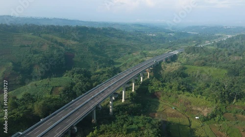 4K Drone Video of Elevated Toll Road Across Green Mountain Terrain

