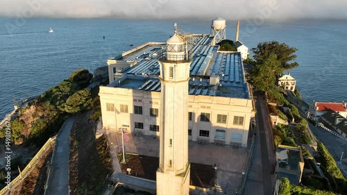 Alcatraz Island In San Francisco California United States. Lighthouse Standing Tall On Beach With Ocean Waves Crashing. Metropolitan Landscape High Rise Building Vibrant.