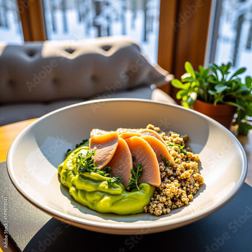 Avocado and quinoa breakfast bowl with flaked smoked trout, hemp seeds, microgreens, and lemon olive oil, served in ceramic bowl photo