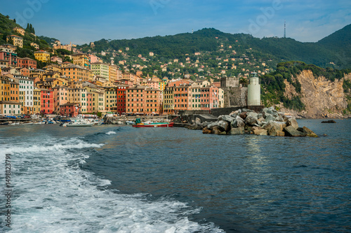 traditional colorful architecture, lighthouse and port of coastal town Camogl...