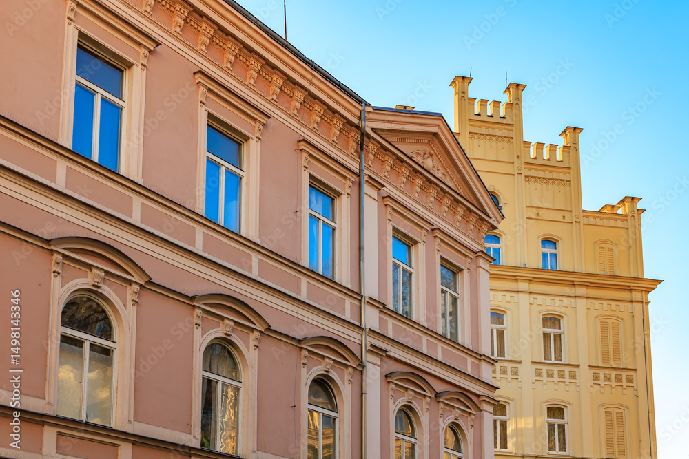 Fototapeta premium Architectural contrast of historic buildings against blue sky