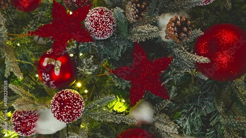 a decorated Christmas tree, a garland of sparkling lights, various Christmas toys in the form of red balls and stars