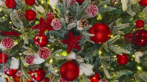 a decorated Christmas tree, a garland of sparkling lights, various Christmas toys in the form of red balls and stars