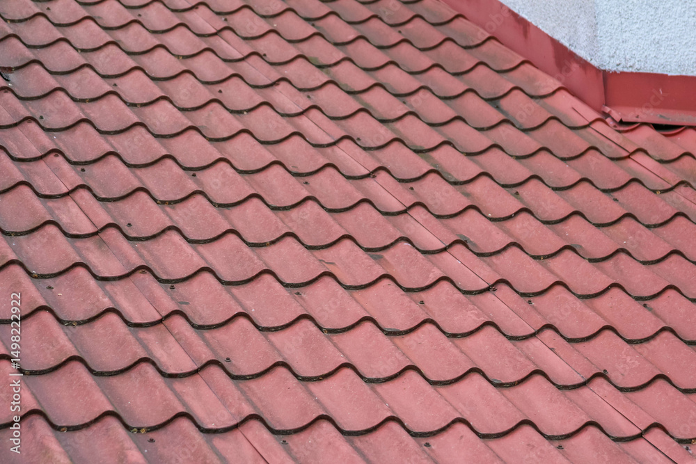 Fototapeta premium Close-up of Red Clay Roof Tiles in Overlapping Pattern Creating Waterproof Home Protection