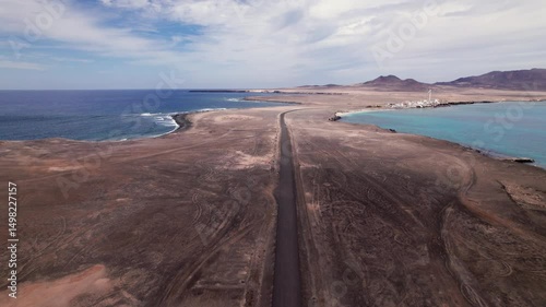 Drone view following desert road in southern Fuerteventura