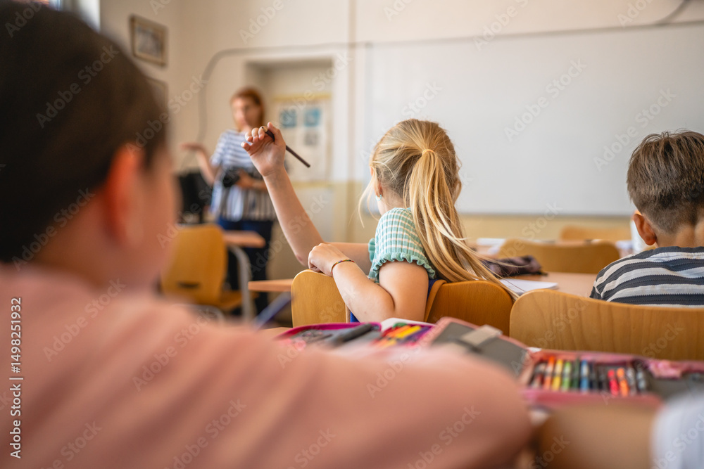 Fototapeta premium pretty school girl pupil sit in school class and talk with classmate