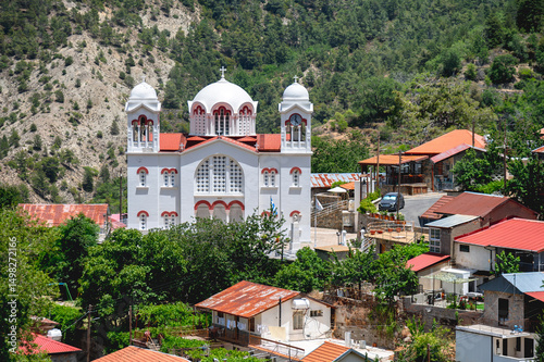 Timios Stavros Church overlooking Pedoulas village in Cyprus with Troodos Mountains rising in the background