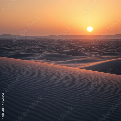 Tranquil desert sunset casting golden light over wind swept dunes creating a vivid contrast with cool blue shadows