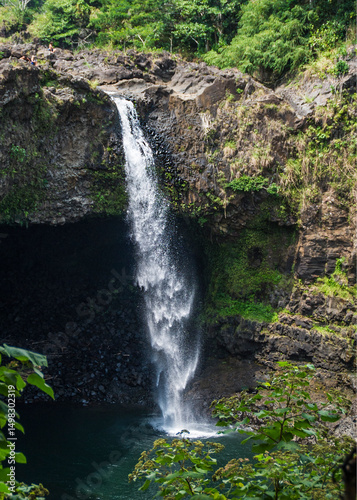 The flow of fresh water from the winter snows dashes over the side of the mountain rocks.