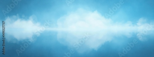 Calm blue sky with soft white clouds reflected perfectly on a still body of water creating a serene and peaceful atmosphere