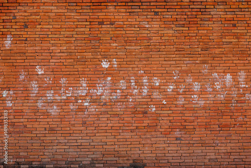 White powder handprints adorn the ancient brick city wall at Tha Phae Gate, Chiang Mai, a common sight during the lively Songkran festival. photo