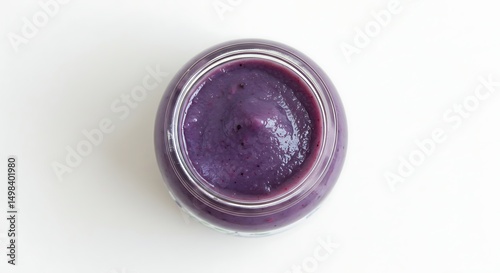 Baby food in glass jar with soft fruit puree