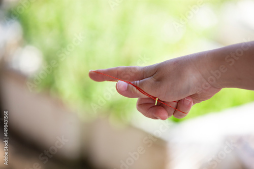 A woman's hands playing with a rubber band