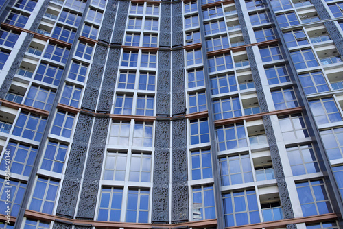Wallpaper Mural Low Angle View Of Modern High-Rise Apartment Building With Numerous Windows Reflecting The Sky Torontodigital.ca