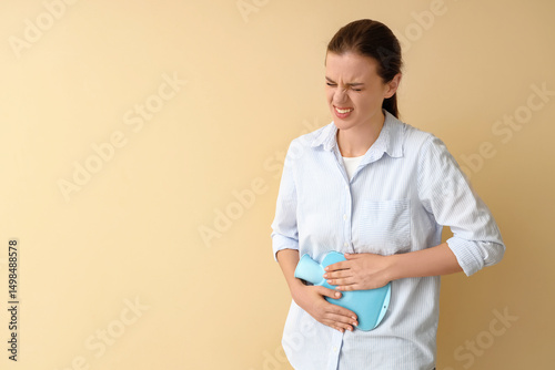 Young woman with hot water ...