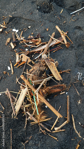 Garbage is scattered on the beach sand
