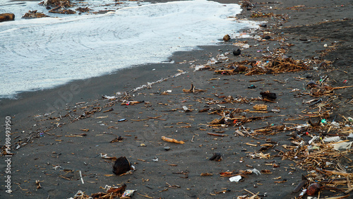 Garbage is scattered on the beach sand