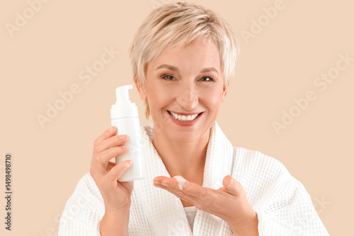 Mature woman with bottle of...