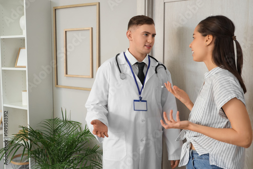 Male doctor talking to youn...