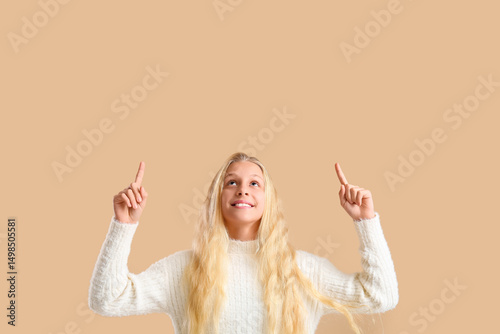 Happy teenager girl pointin...