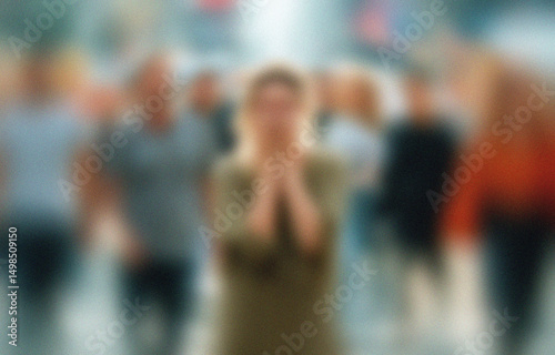 Wallpaper Mural Woman with hands clasped in prayer, surrounded by a blurred crowd, seeking solace, hope, faith, urban background, emotional connection.

 Torontodigital.ca