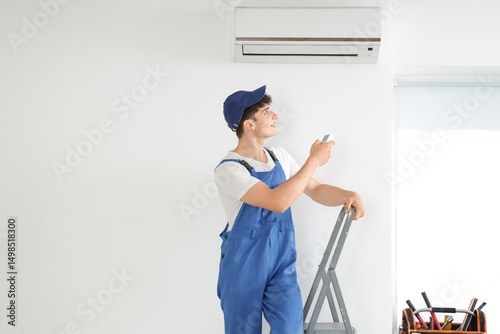 Male worker repairing air c...