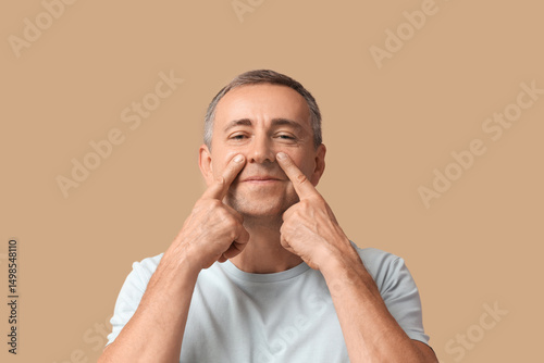 Happy mature man doing face...