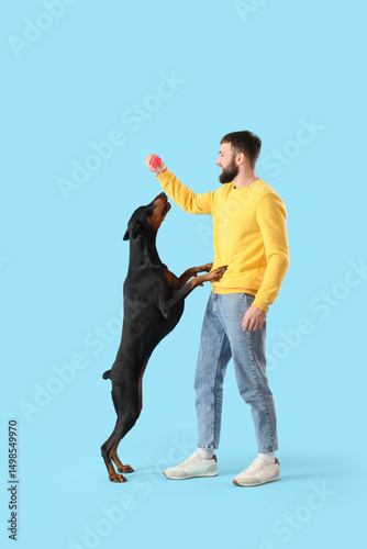Young man playing with Dobe...