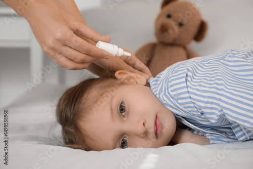 Mother putting drops in her...