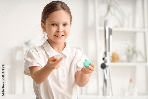 Cute little girl with conta...