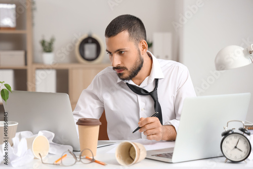 Stressed businessman workin...