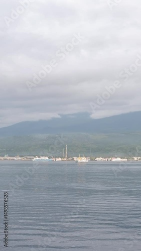 Hazy Coastal View of a Distant Island Town