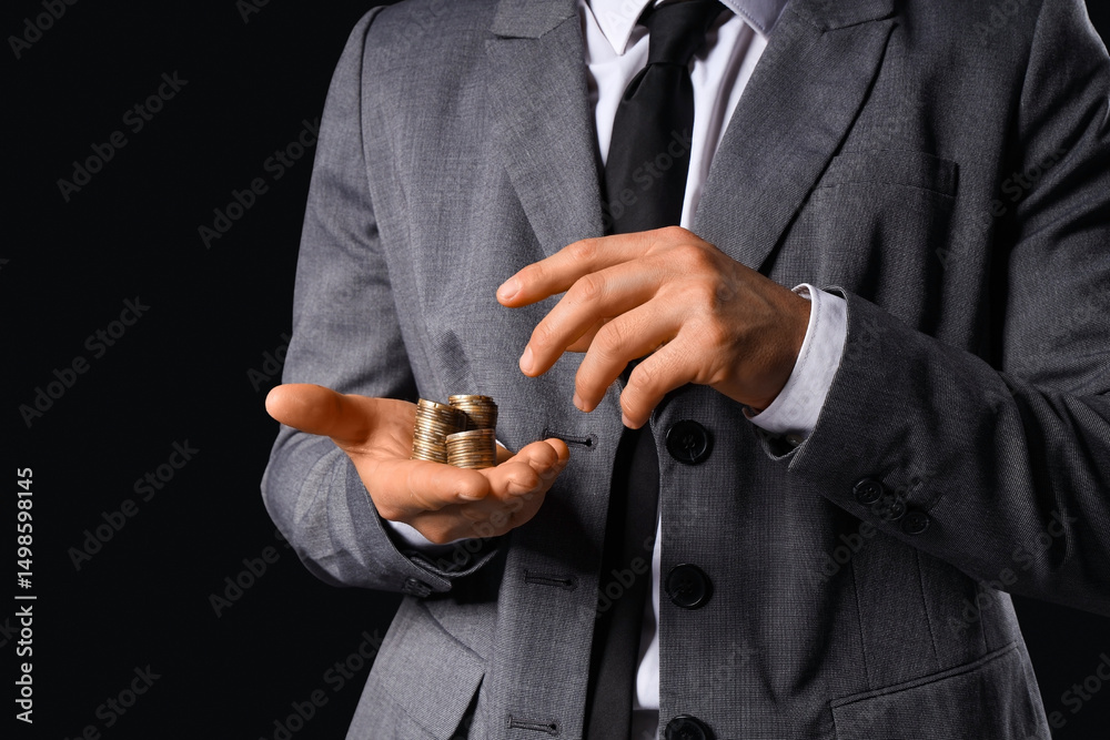 Fototapeta premium Businessman counting coins on black background, closeup