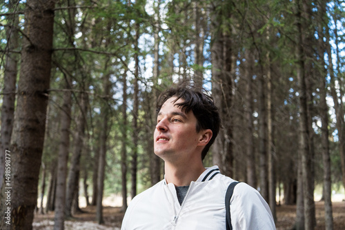 Man smiling in a sunlit forest