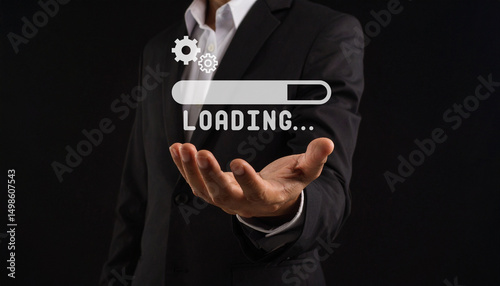A person in a suit holds out their hand, with a digital loading bar and icons floating above it on a dark background.
